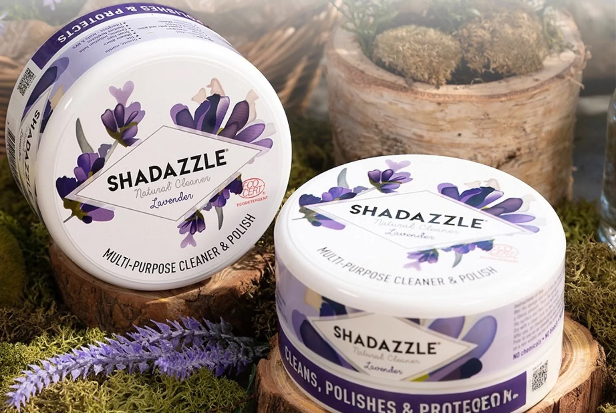 Two tubs of Shadazzle Cleaner & Polish in lavender on moss and wood slices